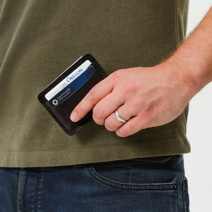 Black | Model hodling minimalist leather wallet with card slots