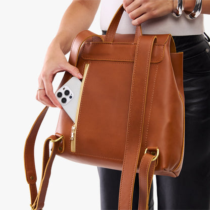 Honey | Model wearing a leather backpack on a white background
