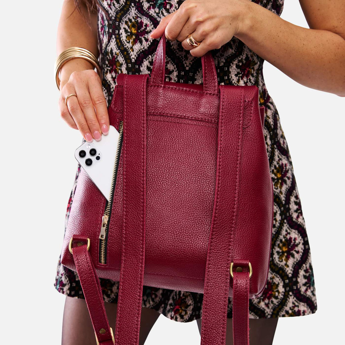 Rhubarb | Model wearing a leather backpack on a white background