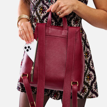 Rhubarb | Model wearing a leather backpack on a white background
