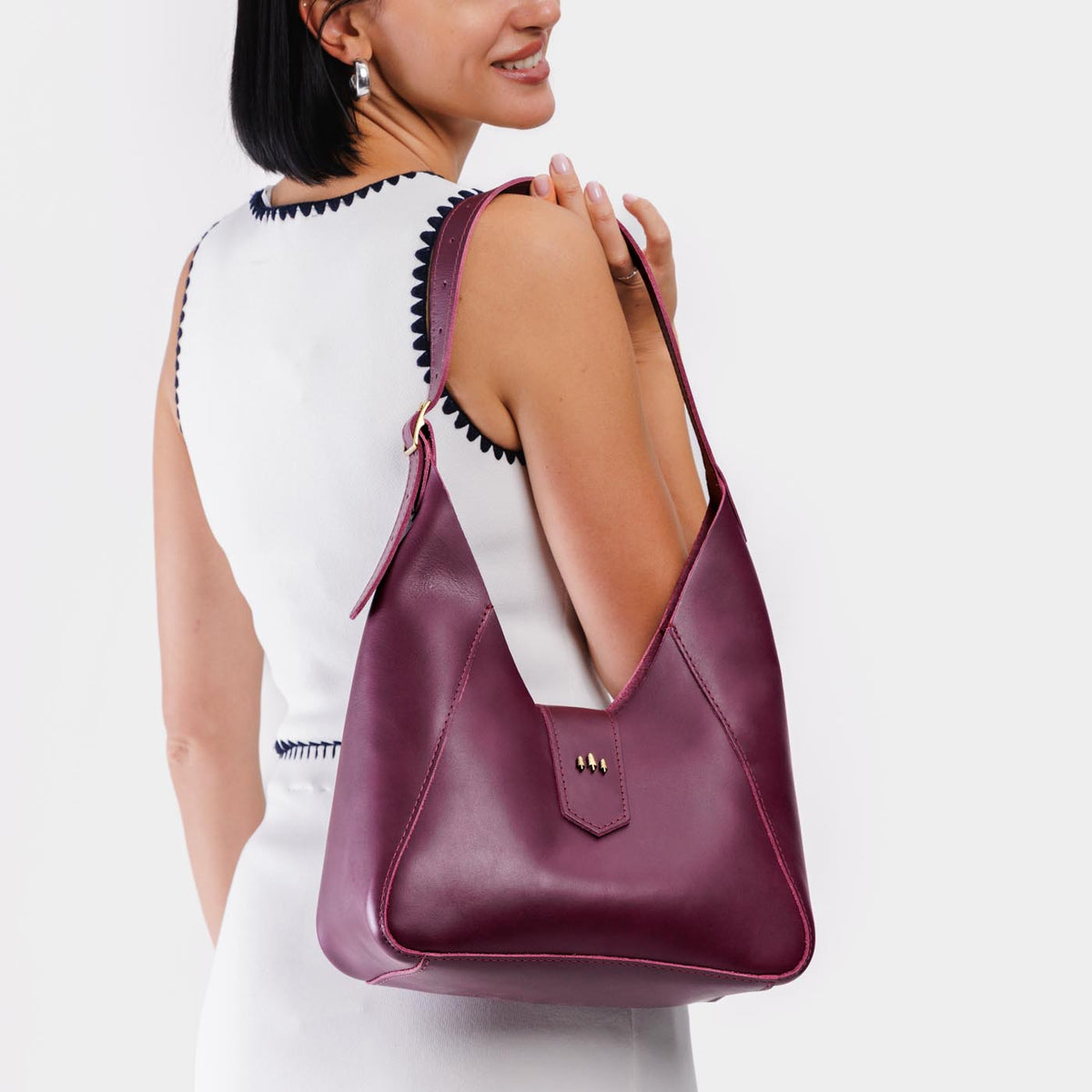 Lollipop | Model wearing structured hobo shoulder bag with adjustable strap and magnetic closure