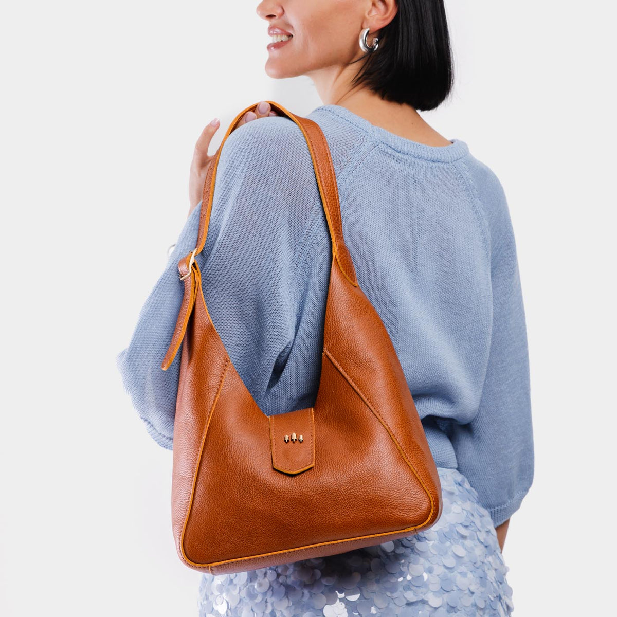 Sienna | Model wearing structured hobo shoulder bag with adjustable strap and magnetic closure