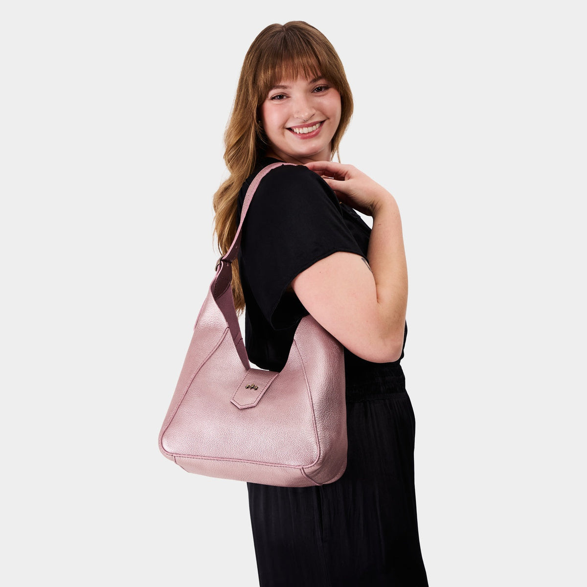 Supernova | Model wearing structured hobo shoulder bag with adjustable strap and magnetic closure