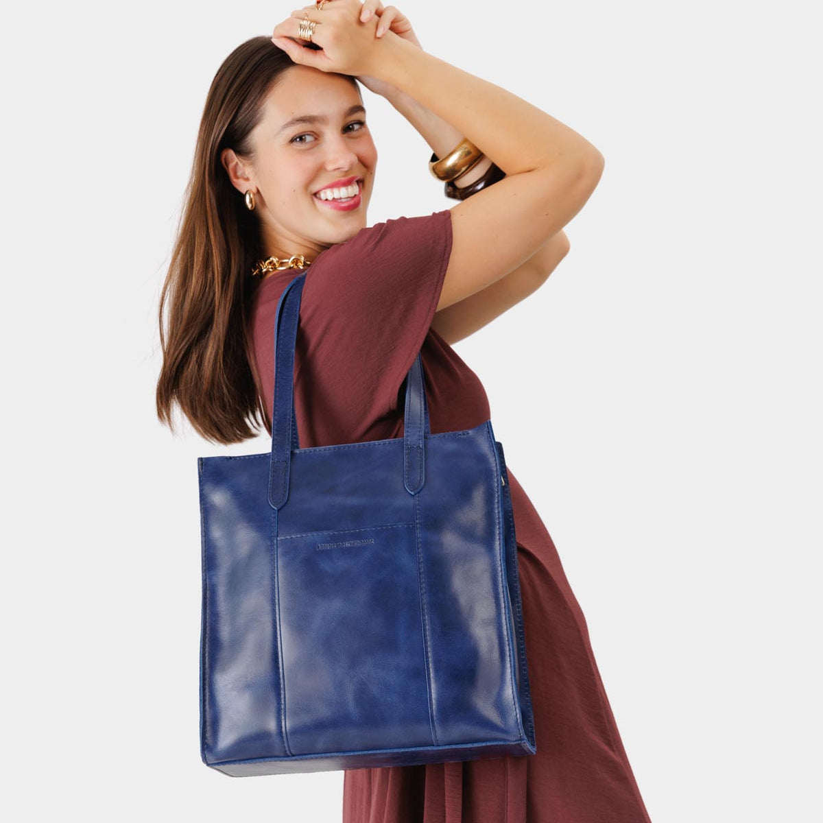 Cowboy Blue*North/South | Model wearing structured large tote bag with overlapping panels and crossbody strap