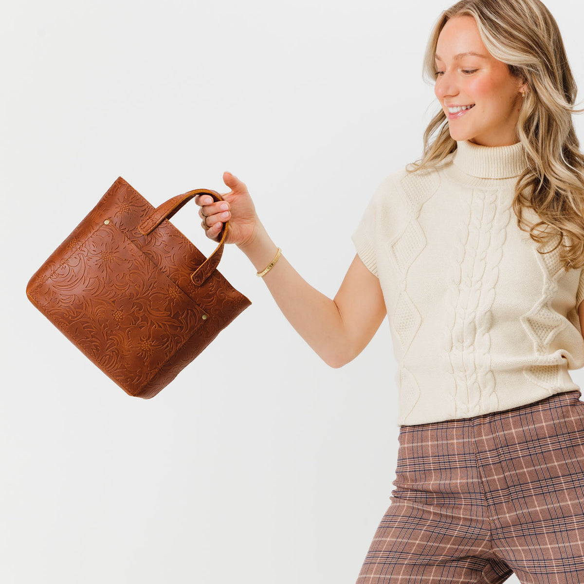 Meadow*Zipper | Model holding crossbody tote bag with zipper closure and front pocket