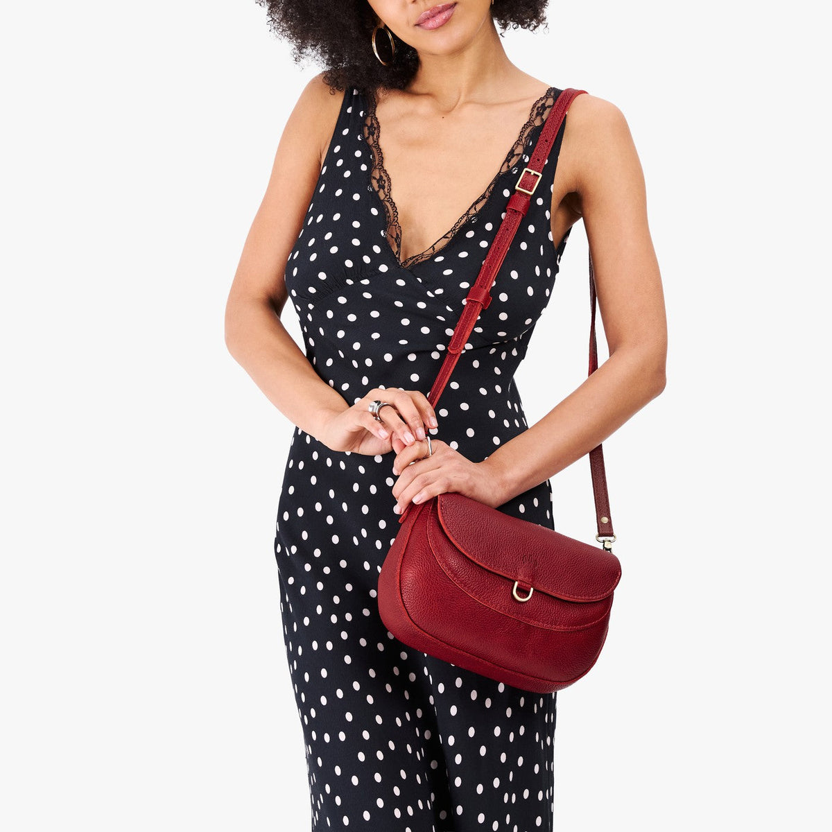 Chili Red*Large | Model wearing a leather Crossbody with a flap and magnetic closure