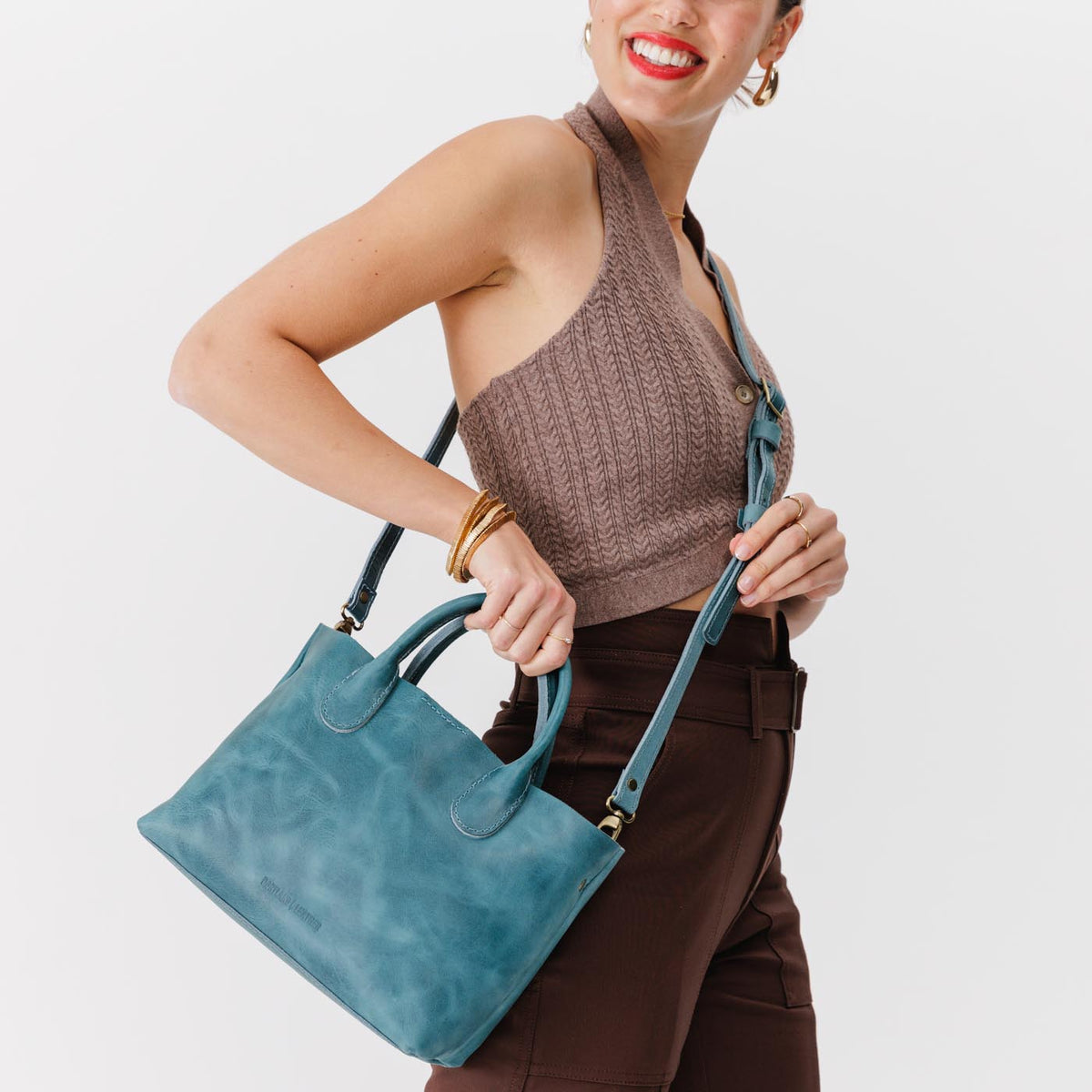 Aqua*Large | Model holding mid-size tote purse with structured leather handles and crossbody strap