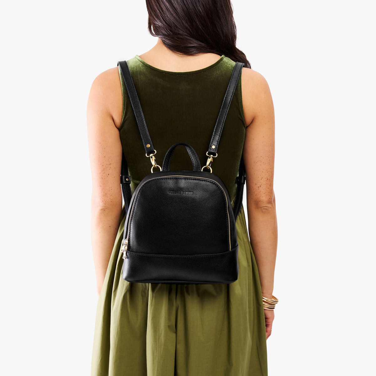 Pebbled--black | Model wearing leather backpack with debossed Portland Leather logo on front