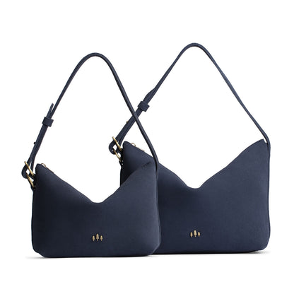 Alaska Blue | Size comparison shot of small and large slouchy leather shoulder bags with zipper opening and three metal tree emblems