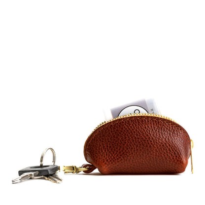 Nutmeg | Taco shaped leather pouch with zipper and swivel lobster clasp on white background