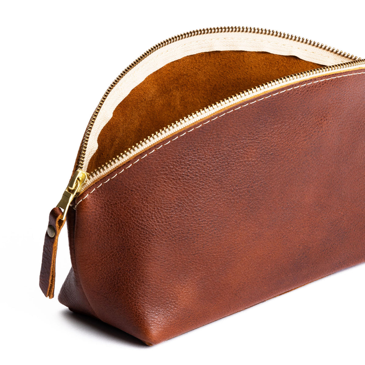 Nutmeg | Spacious leather makeup bag with curved seams and top zipper open